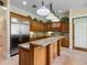 Traditional-style kitchen with wood cabinets, granite countertops, and stainless steel refrigerator at 9501 Tavistock Rd, Orlando, FL 32827