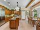 Spacious kitchen featuring custom cabinets, granite countertops, and an adjacent dining area at 9501 Tavistock Rd, Orlando, FL 32827