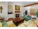 Cozy living room featuring a fireplace, comfortable seating, and large windows at 9501 Tavistock Rd, Orlando, FL 32827