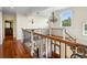 Elegant staircase features wooden banisters, wrought iron railings, and a view of the front door at 9501 Tavistock Rd, Orlando, FL 32827