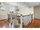Bright staircase featuring wood and wrought iron details, offering a glimpse of the upper level at 9501 Tavistock Rd, Orlando, FL 32827