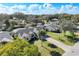 Aerial view of the home, highlighting the well-manicured lawn, mature trees, and long driveway at 10012 Silver Bluff Dr, Leesburg, FL 34788