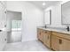 Bright bathroom with double vanity, granite countertop, and tile flooring overlooking the screened-in lanai at 10012 Silver Bluff Dr, Leesburg, FL 34788