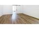 Bedroom featuring wood laminate flooring, and closet with a sliding barn door at 10012 Silver Bluff Dr, Leesburg, FL 34788