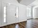 Bright foyer with a modern front door with sidelights and beautiful wood-look floors at 10012 Silver Bluff Dr, Leesburg, FL 34788