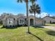 Charming home featuring a well-manicured lawn and stucco facade and well-lit by large windows at 10012 Silver Bluff Dr, Leesburg, FL 34788