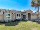 Charming home featuring a well-manicured lawn and stucco facade and well-lit by large windows at 10012 Silver Bluff Dr, Leesburg, FL 34788
