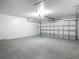 Spacious garage featuring epoxy flooring and ample room for vehicles and storage at 10012 Silver Bluff Dr, Leesburg, FL 34788