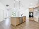 Bright and airy kitchen features a large island, stainless steel appliances, and an open floor plan to the living area at 10012 Silver Bluff Dr, Leesburg, FL 34788