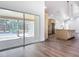 Bright kitchen with views through sliding doors with an island and modern pendant lights at 10012 Silver Bluff Dr, Leesburg, FL 34788
