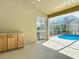Outdoor lanai with pool access featuring convenient cabinetry for outdoor entertaining at 10012 Silver Bluff Dr, Leesburg, FL 34788