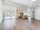 Bright living room with an open layout to kitchen and pool views through the glass doors at 10012 Silver Bluff Dr, Leesburg, FL 34788