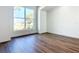 Bright living room featuring wood-look floors and a large window letting in plenty of natural light at 10012 Silver Bluff Dr, Leesburg, FL 34788