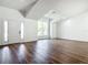 Open-concept living room with hard surface floors and a front door with sidelights at 10012 Silver Bluff Dr, Leesburg, FL 34788