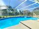 Sparkling pool with screened enclosure, perfect for relaxing and entertaining in a private backyard at 10012 Silver Bluff Dr, Leesburg, FL 34788