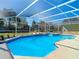 Beautiful pool with screened enclosure, providing a perfect oasis for outdoor enjoyment and relaxation at 10012 Silver Bluff Dr, Leesburg, FL 34788
