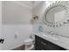 Small bathroom with decorative mirror above the sink and wainscoting on the wall at 1024 Harbor Hill St, Winter Garden, FL 34787