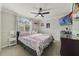 Bedroom featuring baseball themed bed coverings, and a large sunny window covered by blinds at 1024 Harbor Hill St, Winter Garden, FL 34787