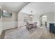 Elegant dining room featuring modern lighting, chair rail, and wood-look flooring at 1024 Harbor Hill St, Winter Garden, FL 34787