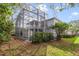 A home's exterior featuring a screened-in patio and pool, surrounded by lush greenery and foliage at 1024 Harbor Hill St, Winter Garden, FL 34787