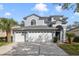 Charming two-story home with a three-car garage and well-manicured landscaping at 1024 Harbor Hill St, Winter Garden, FL 34787
