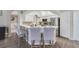 Modern kitchen featuring stainless steel appliances, white cabinets, and bar seating at 1024 Harbor Hill St, Winter Garden, FL 34787