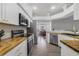 Bright kitchen with stainless steel appliances, wood countertops, and white cabinetry at 1024 Harbor Hill St, Winter Garden, FL 34787
