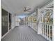 Covered lanai with a ceiling fan, white railings, and a view of the backyard and beyond at 1024 Harbor Hill St, Winter Garden, FL 34787