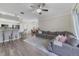 Bright open floor plan featuring living room, kitchen, breakfast nook, and an oversized gray sectional sofa at 1024 Harbor Hill St, Winter Garden, FL 34787