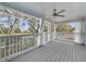 Screened in porch with white railings and supports, and an outdoor ceiling fan at 1024 Harbor Hill St, Winter Garden, FL 34787