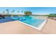 A large community swimming pool with brick trim and slide under a sunny blue sky at 1024 Harbor Hill St, Winter Garden, FL 34787
