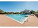 A large community swimming pool featuring brick trim, blue sky, and an inviting clubhouse at 1024 Harbor Hill St, Winter Garden, FL 34787