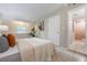 Serene bedroom featuring a tufted headboard, soft linens, and minimalist decor for a relaxing ambiance at 103 Ford Ave, Altamonte Springs, FL 32701