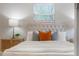 Bright bedroom with a tufted headboard, stylish nightstands and throw pillows adds a touch of elegance at 103 Ford Ave, Altamonte Springs, FL 32701