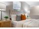 Bright bedroom with a tufted headboard, stylish nightstands and throw pillows adds a touch of elegance at 103 Ford Ave, Altamonte Springs, FL 32701