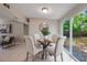 Dining area with a table setting and natural light coming through sliding glass doors at 103 Ford Ave, Altamonte Springs, FL 32701