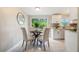 Bright dining area features a modern table setting, a sliding glass door with backyard views, and white cabinetry at 103 Ford Ave, Altamonte Springs, FL 32701