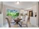 An airy dining area provides backyard views through a sliding glass door with a cozy, modern feel at 103 Ford Ave, Altamonte Springs, FL 32701