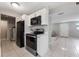 Updated kitchen with black stainless appliances, white cabinets, and tile flooring at 103 Ford Ave, Altamonte Springs, FL 32701