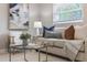 Comfortable living room featuring neutral tones, modern decor, a glass coffee table, and natural light at 103 Ford Ave, Altamonte Springs, FL 32701
