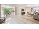 Open-concept living room showcases neutral tones, tile floors, and seamless flow into the dining and kitchen areas at 103 Ford Ave, Altamonte Springs, FL 32701