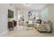 Bright living room with tile floors, comfortable seating, modern decor, and an open view to the bedroom at 103 Ford Ave, Altamonte Springs, FL 32701