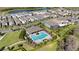 Aerial view of community pool and surrounding homes near lake at 12064 Encore At Ovation Way, Winter Garden, FL 34787