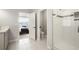 Bright bathroom, with a glass shower and open access to the main bedroom at 12064 Encore At Ovation Way, Winter Garden, FL 34787