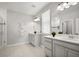 Bright bathroom featuring dual sinks, and a glass-enclosed shower at 12064 Encore At Ovation Way, Winter Garden, FL 34787