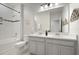 Bathroom featuring double sinks, tiled shower, and decorative accents at 12064 Encore At Ovation Way, Winter Garden, FL 34787