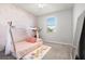 Bright bedroom with a play canopy over the bed and rainbow accent decorations at 12064 Encore At Ovation Way, Winter Garden, FL 34787