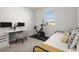 Bright bedroom featuring an exercise bike and modern computer setup at 12064 Encore At Ovation Way, Winter Garden, FL 34787
