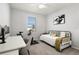 Well-lit bedroom featuring desk, stationary bike and stylish decor at 12064 Encore At Ovation Way, Winter Garden, FL 34787