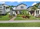Charming two-story home with a manicured lawn, lush landscaping, and a welcoming entrance at 12064 Encore At Ovation Way, Winter Garden, FL 34787